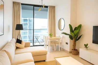 a living room with a couch and a table at 2BR Luxury Baby, Gym & Pool in Dubai