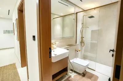 a bathroom with a toilet and a sink and a shower at 2BR Luxury Baby, Gym & Pool in Dubai