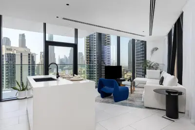 a kitchen and living room with large windows at Maison Privee - Sky-High Panoramic Apt with Iconic Burj Khalifa Vws in Dubai