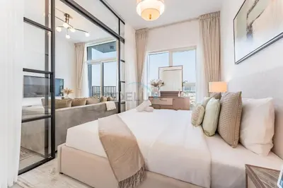 a bedroom with a large white bed and large windows at Walk to Dubai Hills Mall, Premium Amenities And Near Dubai Hills Park And Golf Club, Socio Tower 1, Dubai Hills by Deluxe Holiday Homes in Dubai