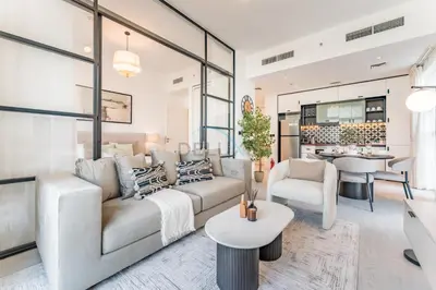 a living room with a couch and a table at Walk to Dubai Hills Mall, Premium Amenities And Near Dubai Hills Park And Golf Club, Socio Tower 1, Dubai Hills by Deluxe Holiday Homes in Dubai