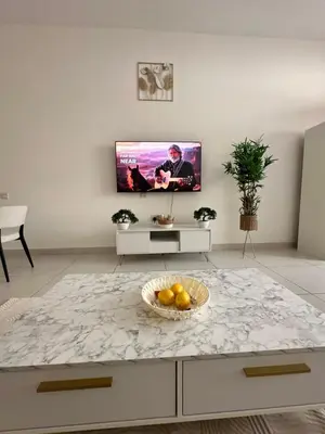 a living room with a table with a bowl of fruit at Luxury studio with full sea view in Dubai