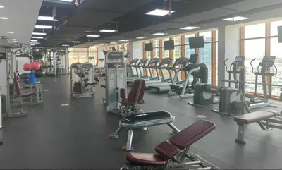a gym with rows of treadmills and machines at Luxury studio with full sea view in Dubai