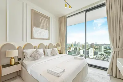 a bedroom with a large white bed and a large window at Golden Stays - Private Pool in Binghatti Onyx I Modern 2BR Apartment I JVC Dubai in Dubai