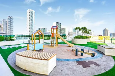 a park with a playground with a swing at Golden Stays - Private Pool in Binghatti Onyx I Modern 2BR Apartment I JVC Dubai in Dubai
