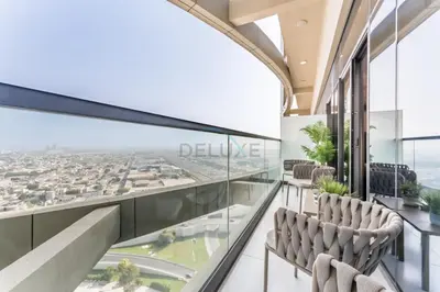 a balcony with chairs and a view of the city at Steps from Dubai Water Canal 2BR, Near Safa Park & SZR, Easy Downtown Access, Aykon City 2 Tower C, Business Bay by Deluxe Holiday Homes in Dubai