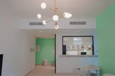 a living room with a ceiling fan and a table at Burj View 1BR Pool,Gym,Sauna,Dubai Mall in Dubai
