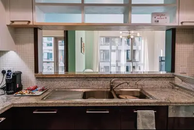 a kitchen counter with a sink and a window at Burj View 1BR Pool,Gym,Sauna,Dubai Mall in Dubai