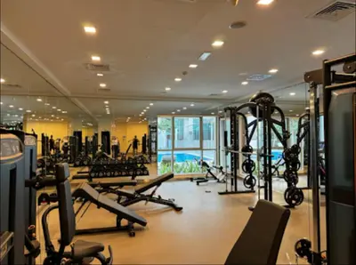 a gym with treadmills and machines in a building at Burj View 1BR Pool,Gym,Sauna,Dubai Mall in Dubai