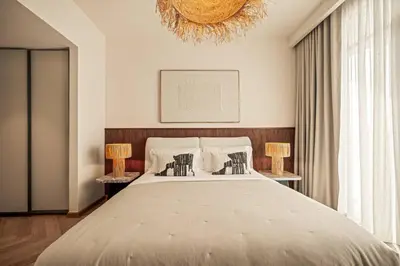 a bedroom with a large bed with two lamps at Seraya Residences at Marina Vista, Emaar Beachfront in Dubai