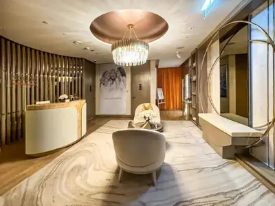 a living room with a couch and a chandelier at Famous Infinity Pool with Burj Khalifa View on High Floor in Dubai