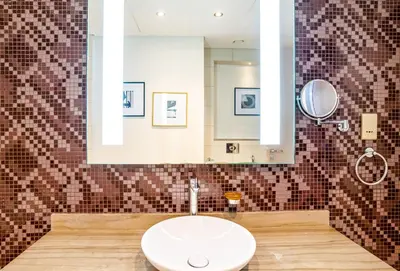 a bathroom with a sink and a mirror at Paramount Tower 1 BR, Hollywood Style Stay in Dubai