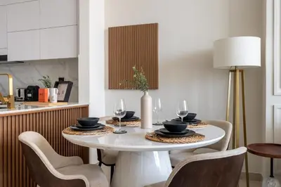 a dining room with a white table and chairs at GuestReady - New Gem | JVC | Binghatti Gardenia in Dubai