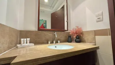 a bathroom with a sink and a mirror at Guest Favorite - Calm and Classy 1BR on High Floor - Walk to Dubai Mall in Dubai