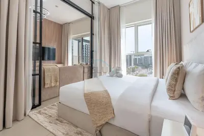 a bedroom with a white bed and a large window at Steps from Dubai Hills Mall, Surrounded by Top-Tier Amenities, and close to Dubai Hills Park and Golf Club, Socio Tower 1, Dubai Hills by Deluxe Holiday Homes in Dubai