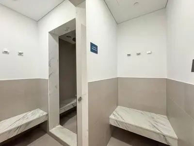 a bathroom with two benches and a mirror at Premium 2BR with Pool, Gym & Lifestyle Amenities in Dubai