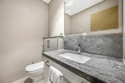 a bathroom with a sink and a toilet at Golden Stays - Luxury 2BR I Burj Views & Direct Dubai Mall Access in Dubai