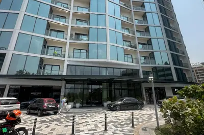 a building with cars parked in front of it at Clever Guest 032 Hartland Waves in Dubai