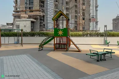 a playground with a slide in a city at Clever Guest 032 Hartland Waves in Dubai