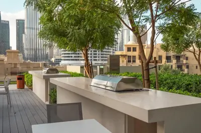 a table with a book on it on top of a building at Downtown Pulse Artful 1BR with Dubai Mall Access by Maxx Value Homes in Dubai
