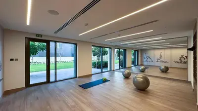 a room with a yoga class with large windows at Downtown Pulse Artful 1BR with Dubai Mall Access by Maxx Value Homes in Dubai