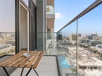 a balcony with a wooden bench and a view of the city at Bright 1 Bedroom Apartment with JVC open view in Dubai