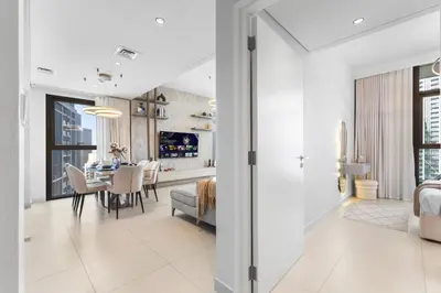 a dining room and living room with a table and chairs at Guest Favorite - Luxury 2BR with Full Burj Khalifa View Downtown in Dubai