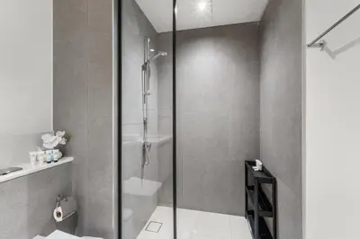 a bathroom with a shower with a glass door at Guest Favorite - Luxury 2BR with Full Burj Khalifa View Downtown in Dubai