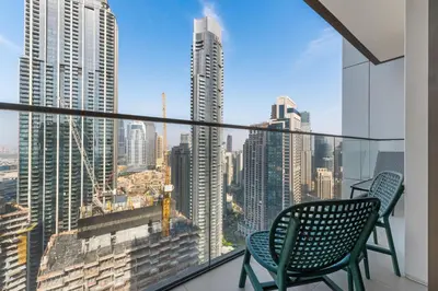 a balcony with two chairs and a view of the city at Guest Favorite - Luxury 2BR with Full Burj Khalifa View Downtown in Dubai
