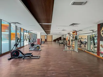a gym with treadmills and exercise equipment in a building at Sunny Studio with Pool, Near Silicon Central Mall in Dubai