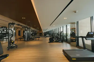 a gym with treadmills and cardio equipment in a building at Mesmerizing Canal View Studio in Trillionaire in Dubai