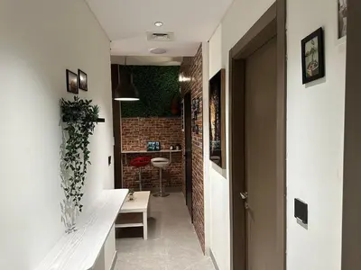 a hallway with a white bench and a brick wall at Luxury Hostel Bedspace in Downtown Near Emirates Towers Metro in Dubai