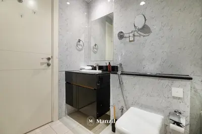 a bathroom with a sink and a toilet and a mirror at Central 1BHK in JVC w Pool near Dubai Sports City in Dubai