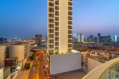 a city skyline at night with a tall building at FIRST CLASS 1BR Stylish Vibe in Dubai