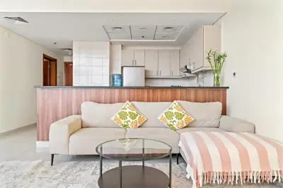 a living room with a couch and a table at FIRST CLASS 1BR Stylish Vibe in Dubai