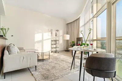 a living room with a couch and a table at FIRST CLASS 1BR Stylish Vibe in Dubai