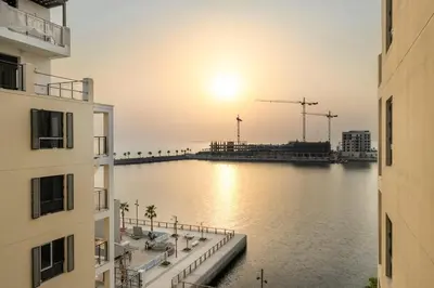 a view of a river between two buildings at Luxury La Mer 1BR Balcony Sea Views Near City Walk and Mall in Dubai