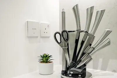 a vase filled with scissors sitting on a counter at Luxury La Mer 1BR Balcony Sea Views Near City Walk and Mall in Dubai