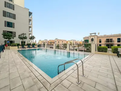 a swimming pool in the middle of a building at Luxury La Mer 1BR Balcony Sea Views Near City Walk and Mall in Dubai