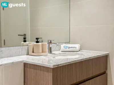 a bathroom counter with a sink and a mirror at HiGuests - Lavish 2BR Apt with Private Beach Access in Dubai