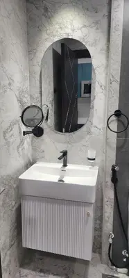 a bathroom with a white sink and a mirror at Opalz by danube science park in Dubai