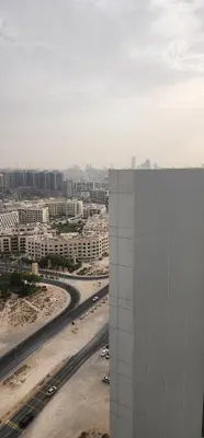 a view of a city with a building and a highway at Opalz by danube science park in Dubai