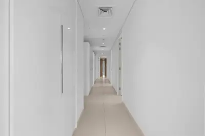 an empty corridor in a building with white walls at Bluewater Residence 6- Spacious Outlet in Dubai