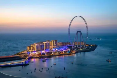 a city with a ferris wheel in the water at night at Bluewater Residence 6- Spacious Outlet in Dubai