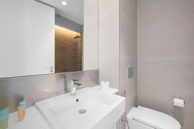 a white bathroom with a sink and a toilet at Bluewater Residence 6- Spacious Outlet in Dubai