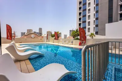 a swimming pool on top of a building at Brand New 1 Bedroom in AURA by Grovy, JVC in Dubai