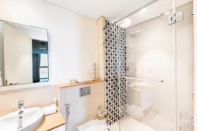 a bathroom with a sink and a shower at Escape 24 Lux 2BR Collective Dubai Hills in Dubai