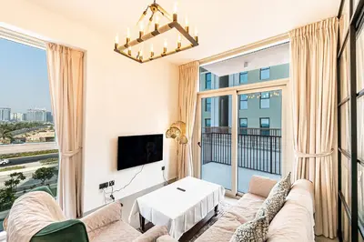 a living room with a couch and a large window at Escape 24 Lux 2BR Collective Dubai Hills in Dubai