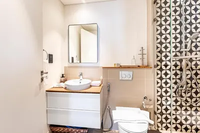a bathroom with a sink and a mirror at Escape 24 Lux 2BR Collective Dubai Hills in Dubai