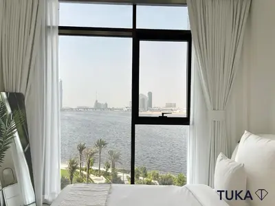 a bedroom with a large window with a view of the water at Canal View - 2-BHK - Creek Harbour - Central - Lux in Dubai